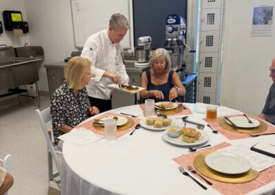 Guests and College of the Desert Culinary Arts students during the President's Circle Culinary Experience, featuring student-prepared meals and chef presentations.