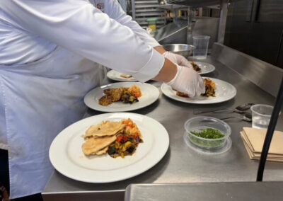 Guests and College of the Desert Culinary Arts students during the President's Circle Culinary Experience, featuring student-prepared meals and chef presentations.